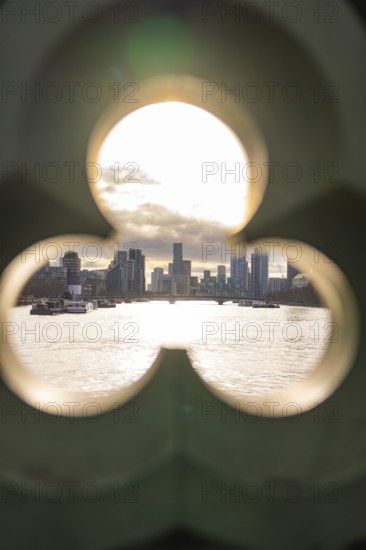 Looking through an opening shows an urban landscape with modern buildings at sunset, London, United Kingdom