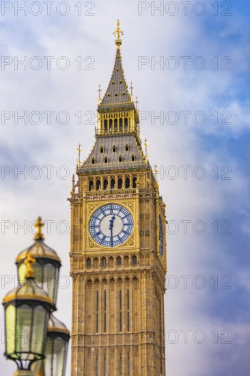 Close-up of a clock tower with gothic architecture against a blue sky, Big Ben, London, United Kingdom