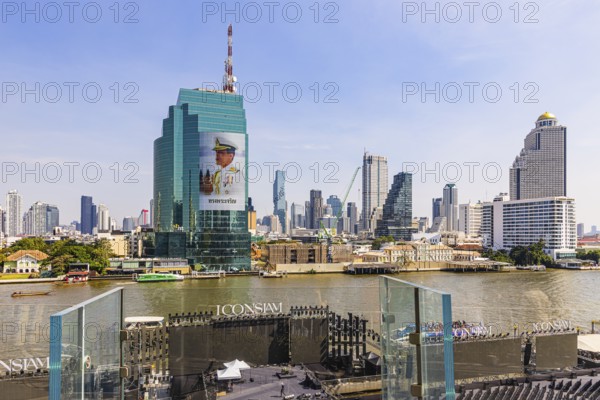 Stage setup for the New Year's Eve party on the terrace and on the Chao Phraya River, Iconsiam Shopping Center, opposite King Power Mahanakhon Tower with the huge portrait of King Maha Vajiralongkorn, Rama X, Bangkok, Thailand's metropolis, Thailand