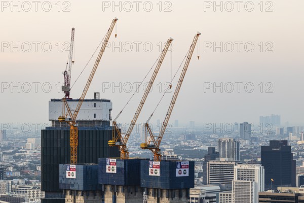 Over the rooftops of Bangkok, construction of a new high-rise building with construction cranes, view from the Moon Bar on the roof terrace of the Banyan Tree hotel, Sathon, Bangkok, Thailand's metropolis, Thailand