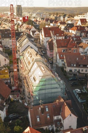 Bird's eye view of a residential area with construction site in the midst of numerous residential buildings, carpentry, renovation, roof extension, Stuttgart, Germany