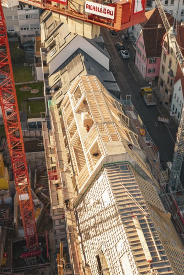 Close-up of construction work on a roof with workers in an urban environment, carpentry, renovation, roof extension, Stuttgart, Germany