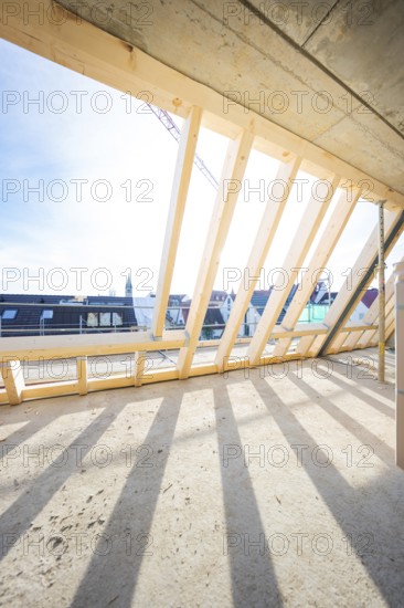Timber structure of a roof truss with shadows under a clear sky, carpentry, renovation, roof extension, Stuttgart, Germany