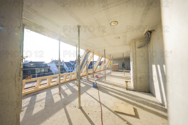 Sunny interior of a construction site with supports and wooden frame, carpentry, renovation, roof extension, Stuttgart, Germany