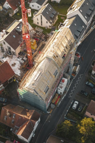 Detailed view of a construction site in a residential area with a crane from above, carpentry, renovation, roof extension, Stuttgart, Germany
