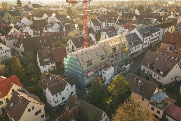 Aerial view of an urban residential area with a visible construction site and a crane, carpentry, renovation, roof extension, Stuttgart, Germany