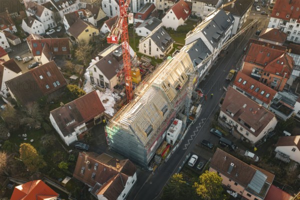 Aerial view of a construction site using cranes and roof work in an urban environment, carpentry, renovation, roof extension, Stuttgart, Germany