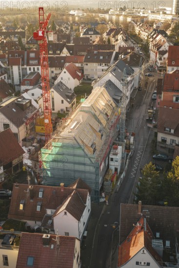 Aerial view of a construction site in a city with an urban environment and roof work, carpentry, renovation, roof extension, Stuttgart, Germany