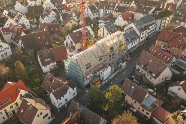 District with a large construction site in the center, taken from above, carpentry, renovation, roof extension, Stuttgart, Germany