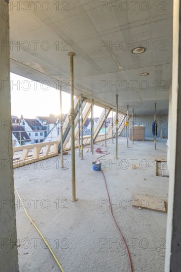 Unfinished interior of a construction site with a view of the residential area, construction site of a carpentry workshop, roof extension, renovation, Stuttgart, Germany