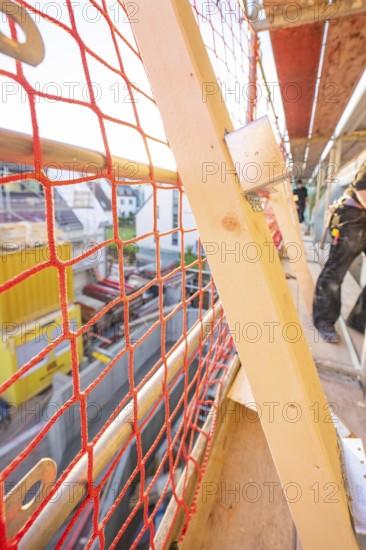 Close-up of a red safety net on scaffolding on a construction site, carpentry construction, roof extension, renovation, Stuttgart, Germany