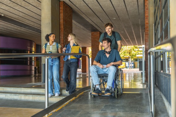 Young diverse students collaborating, navigating a modern university building ramp, showing inclusion and accessibility on campus while moving between classes