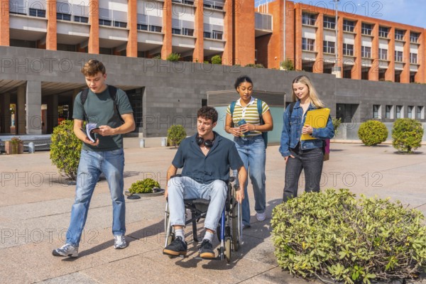 Group of diverse university students, including a young man in a wheelchair, walking together through a modern campus area, representing inclusion, friendship, and accessibility in education