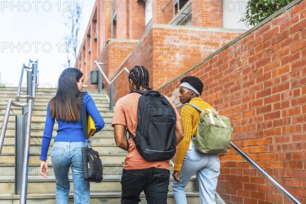 Group of diverse university students with backpacks and books walking up outdoor stairs, symbolizing educational journey, progress, and ambition towards future careers