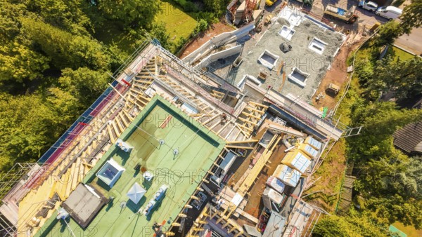 Aerial view of a construction site with roof structures and materials in a green environment, construction site of a carpentry workshop, roof extension, renovation, Stuttgart, Germany