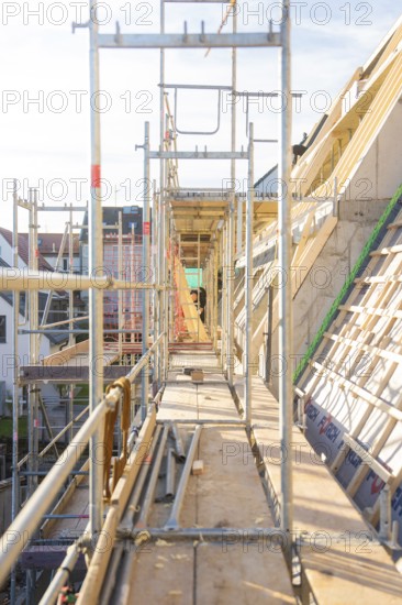 A long corridor with scaffolding on a construction site with wooden structures, carpentry construction, roof extension, renovation, Stuttgart, Germany