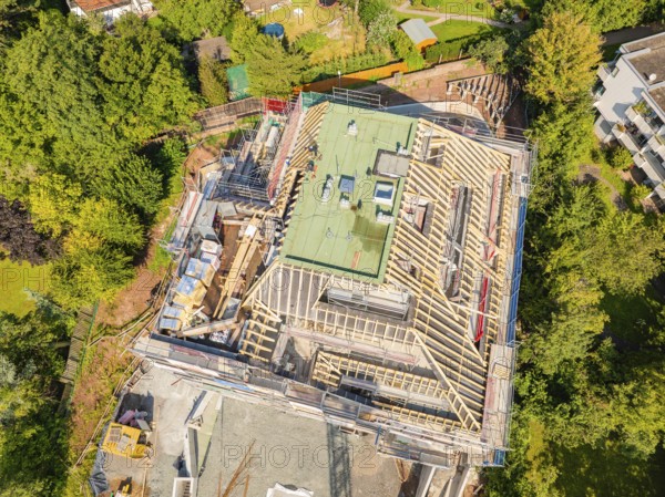 Bird's eye view of a building with roof structure, surrounded by green landscape, carpentry construction, roof extension, renovation, Stuttgart, Germany