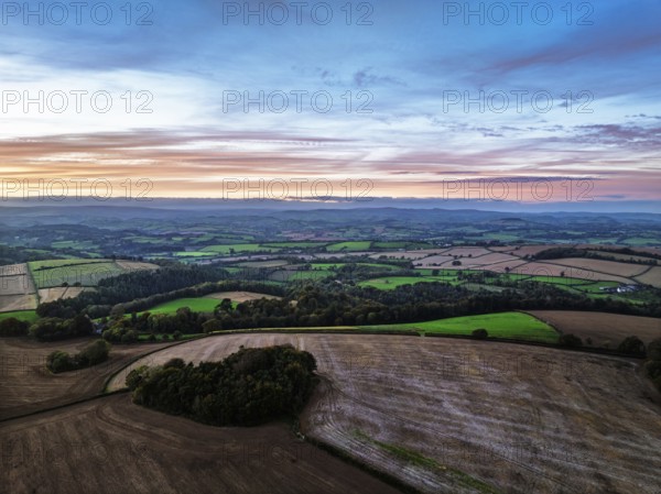 Sunset of Devon Farms and Fields over Berry Pomeroy from a drone, Totnes, England, United Kingdom