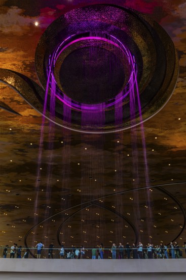 Artificial, brightly lit waterfall, Magic Waterfall, falls from the ceiling of the Iconsiam shopping center, Bangkok, Thailand's metropolis