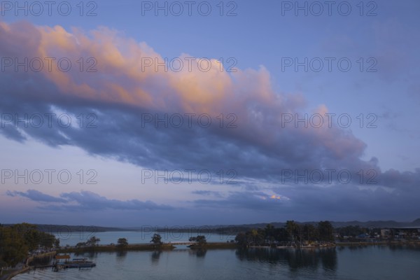 Scenic sunsets and colourful colonial architecture of historic center of Flores, Guatemala. View of lake Peten Itza, Flores Lake