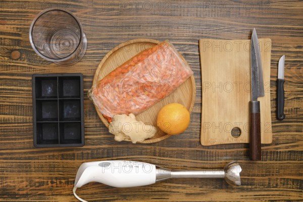 Top view of ingredients for vitamin orange and sea buckthorn tea base arranged on wooden tabletop