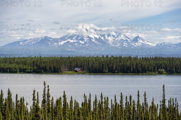 House on Lake Willow Lake, Taiga landscape with high glaciated mountain peak Mount Drum, Wrangell Mountains, Alaska, USA