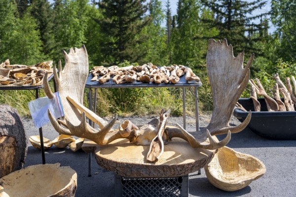 Sales stand for souvenirs with elk antlers and wood carving, Alaska, USA