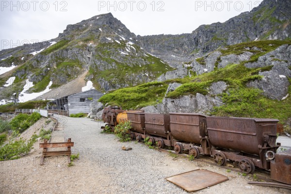 Old rusted mine trucks from the former Gold Mine Independence Mine in mountainous landscape, Independence Mine State Historical Park, Hatcher Pass, Talkeetna Mountains, Alaska, USA