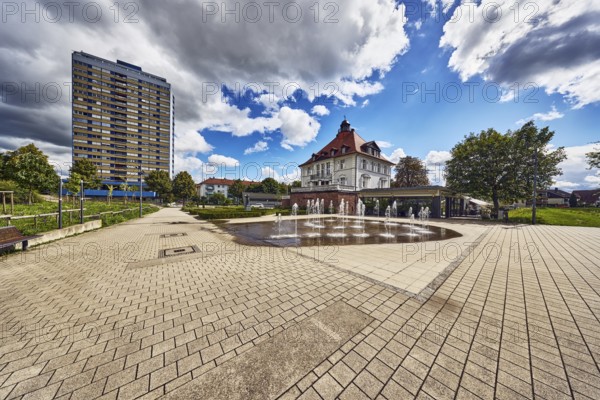 Villa Schmidt restaurant, park, fountain, hedge, lawn, paths, residential buildings, residential high-rise building, trees, blue partly cloudy sky, cumulus clouds, cumulus congestus clouds, Kehl, Upper Rhine Plain, Ortenaukreis, Baden-Württemberg, Germany