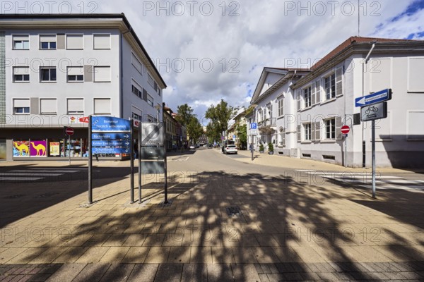 Traffic sign end of pedestrian zone, registry office, wine distillery house, residential buildings and commercial buildings, houses, general architecture, street, shops, shopping, retail, traffic sign one-way street, tourist signpost, welcome sign, sunlight, cloudy, Nimbostratus clouds, intersection of main street with commercial road, Kehl, Upper Rhine Valley, Ortenaukreis, Baden-Württemberg, Germany