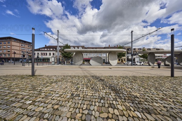 Kehl Rathaus tram stop, trolley masts, overhead lines, lantern, general architecture, houses, buildings, walkway made of natural stones, blue partly cloudy sky, cumulus clouds, cumulus congestus clouds, main street, Kehl, Upper Rhine plain, Ortenau district, Baden-Württemberg, Germany