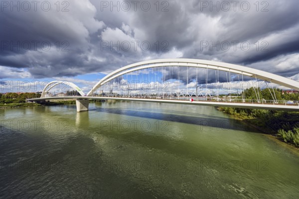 Beatus-Rhenanus bridge, pedestrian and tram bridge, architect Marc Barani, Rhine river, border between Germany and France, border river, rainy mood, partly cloudy blue sky, cumulus clouds, cumulus congestus clouds, Kehl, Upper Rhine plain, Ortenau district, Baden-Württemberg, Germany