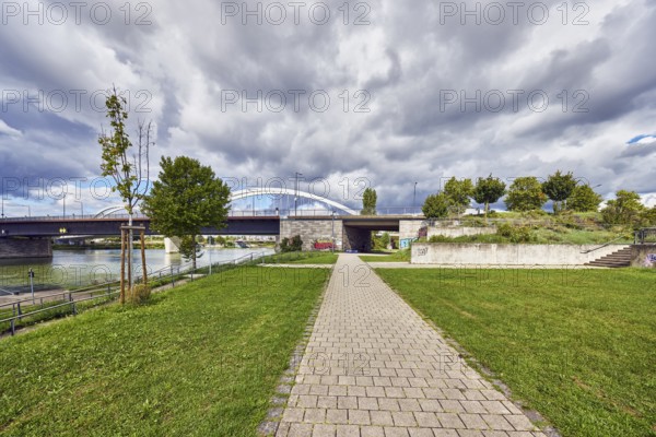 Beatus-Rhenanus bridge, pedestrian and tram bridge, architect Marc Barani, Rhine river, border between Germany and France, border river, park, trees, grass, paths, partly cloudy blue sky, cumulus clouds, cumulus congestus clouds, Kehl, Upper Rhine plain, Ortenau district, Baden-Württemberg, Germany