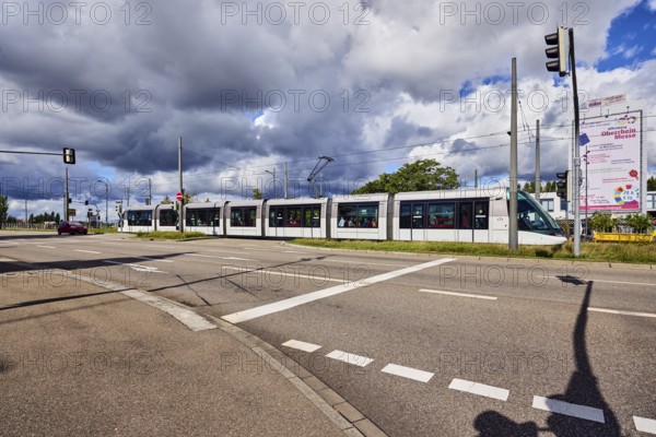 Tram, street, sidewalk, lanes, overhead line, central island, trees, meadow, rainy mood, blue sky, cumulus congestus clouds, cumulus congestus clouds, confluence of main street in Strassburger Straße, Kehl, Upper Rhine Plain, Ortenau district, Baden-Württemberg, Germany