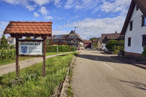 Tourist sign Hohnhurst - southernmost village in Hanauerland, houses, general development, road, hedge, meadow, blue sky, cumulus clouds, district road K5329, Hanauerlandstraße, district Hohnhurst, Kehl, Upper Rhine Plain, Ortenaukreis, Baden-Württemberg, Germany