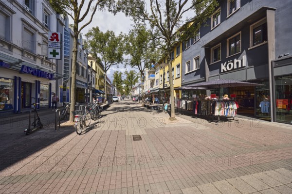 Pedestrian zone, residential and commercial buildings, general architecture, buildings, row of houses, shops, shopping, retail stores, fashion store Mode Köhl, pharmacy anchor pharmacy, bicycle rack with bicycles, city trees, blue sky, cumulus clouds, main street, Kehl, Upper Rhine Valley, Ortenau district, Baden-Württemberg, Germany