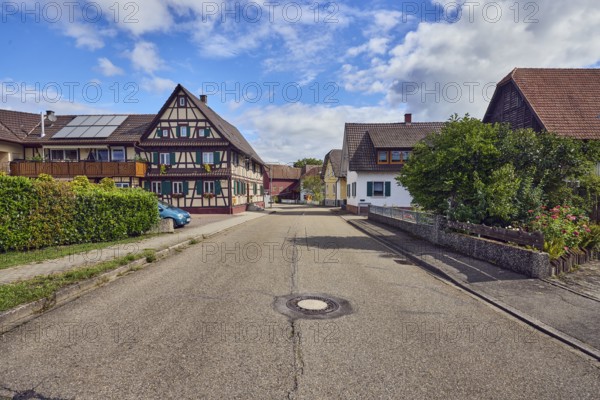 Historic half-timbered house, residential buildings, general development, street, trees, hedge, blue sky, cumulus clouds, district road K5329, Hanauerlandstraße, district of Hohnhurst, Kehl, Upper Rhine Plain, Ortenaukreis, Baden-Württemberg, Germany