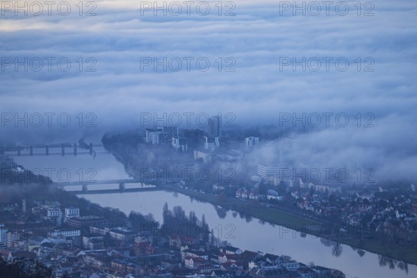 Aerial view of the city of Heidelberg on the Neckar, fog landscape of low-hanging clouds and fog fields floating and waving above the roofs of the city and the Neckar, Heidelberg, Baden-Württemberg, Germany