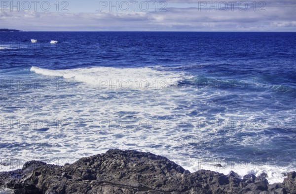 Open seascape with rocky shore and expansive horizon under blue sky, Playa del Janubio, Yaiza Lanzarote