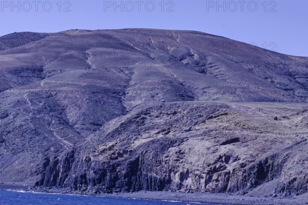 Large rocks and mountains along the coastline that extend into the sea, Playa Quemada, Yaiza Lanzarote