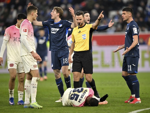 After a foul on Christian Kofane Bayer 04 Leverkusen (35) on the ground, referee Daniel Schlager awards a free kick, gesture Wouter Burger TSG 1899 Hoffenheim (18) Albian Hajdari TSG 1899 Hoffenheim (21) Patrik Schick Bayer 04 Leverkusen (14) PreZero Arena, Sinsheim, Baden-Württemberg, Germany