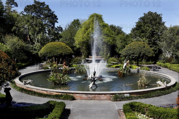 Circular fountain in the middle of a green garden, zero