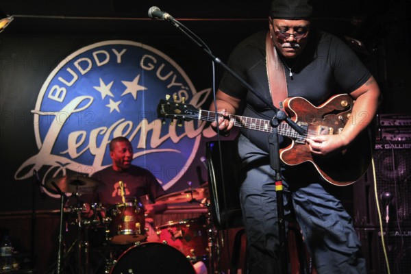 A guitarist plays passionately in a blues club, the intensity of the music is palpable, Chicago, Illinois, USA