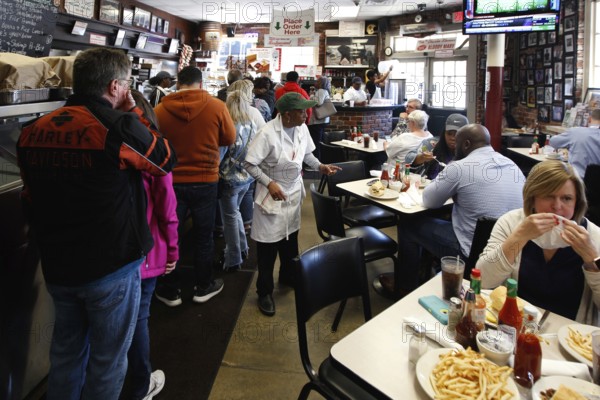 Bustling restaurant with guests and staff enjoying typical southern cuisine, New Orleans, Louisiana, USA
