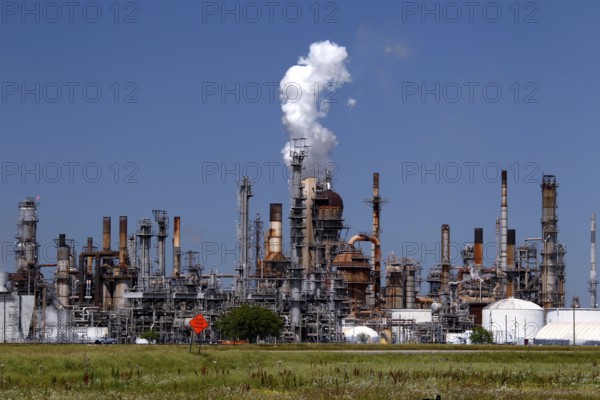 Large refinery plant with smoking chimneys and industrial structures, Mississippi Valley, USA
