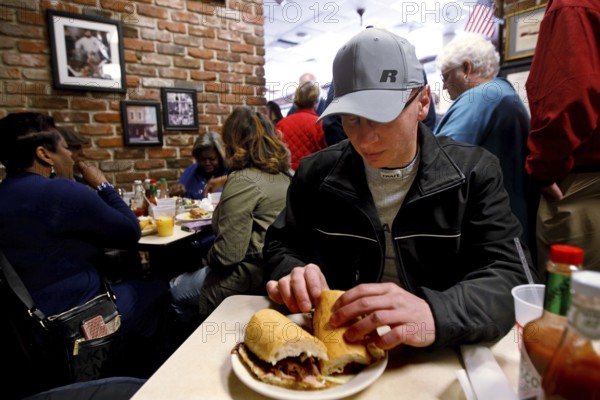 Lively restaurant interior, guests enjoy sandwiches in a relaxed atmosphere, New Orleans, Louisiana, USA