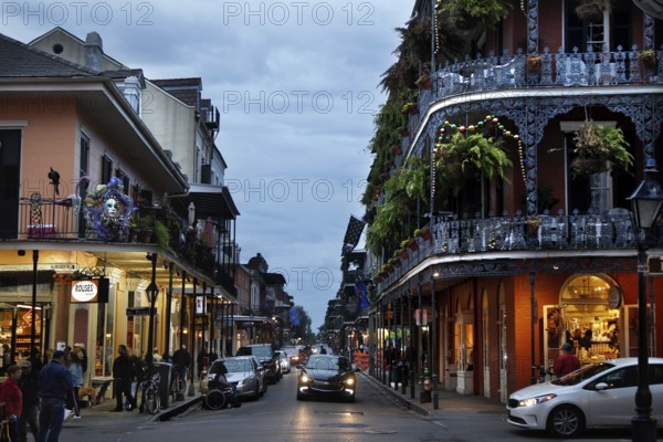 Night view of a busy street in the French Quarter with illuminated shops, New Orleans, Louisiana, USA