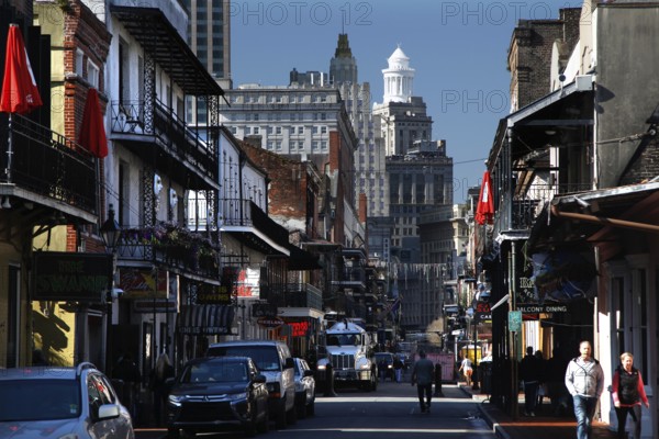 Bustling Bourbon Street in the French Quarter with colonial architecture and pedestrians, New Orleans, Louisiana, USA