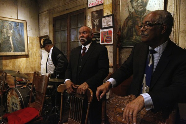 Musician at Preservation Hall ready for a jazz performance in a stylish atmosphere, New Orleans, Louisiana, USA