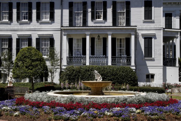 Nottoway Plantation mansion with decorative fountain and colorful flower bed, zero